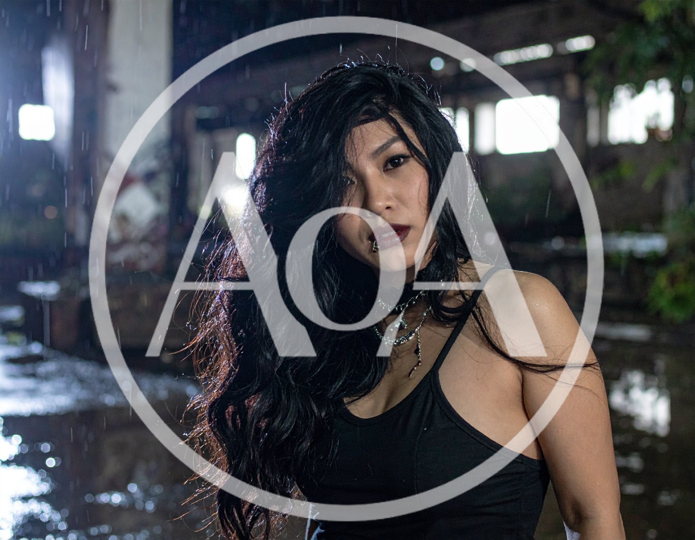 Gothic Woman Standing In Rain At Abandoned Warehouse