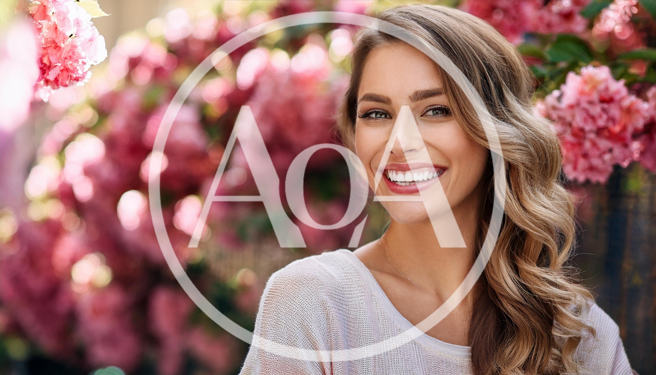 Smiling Woman Posing Outdoors With Pink Flowers