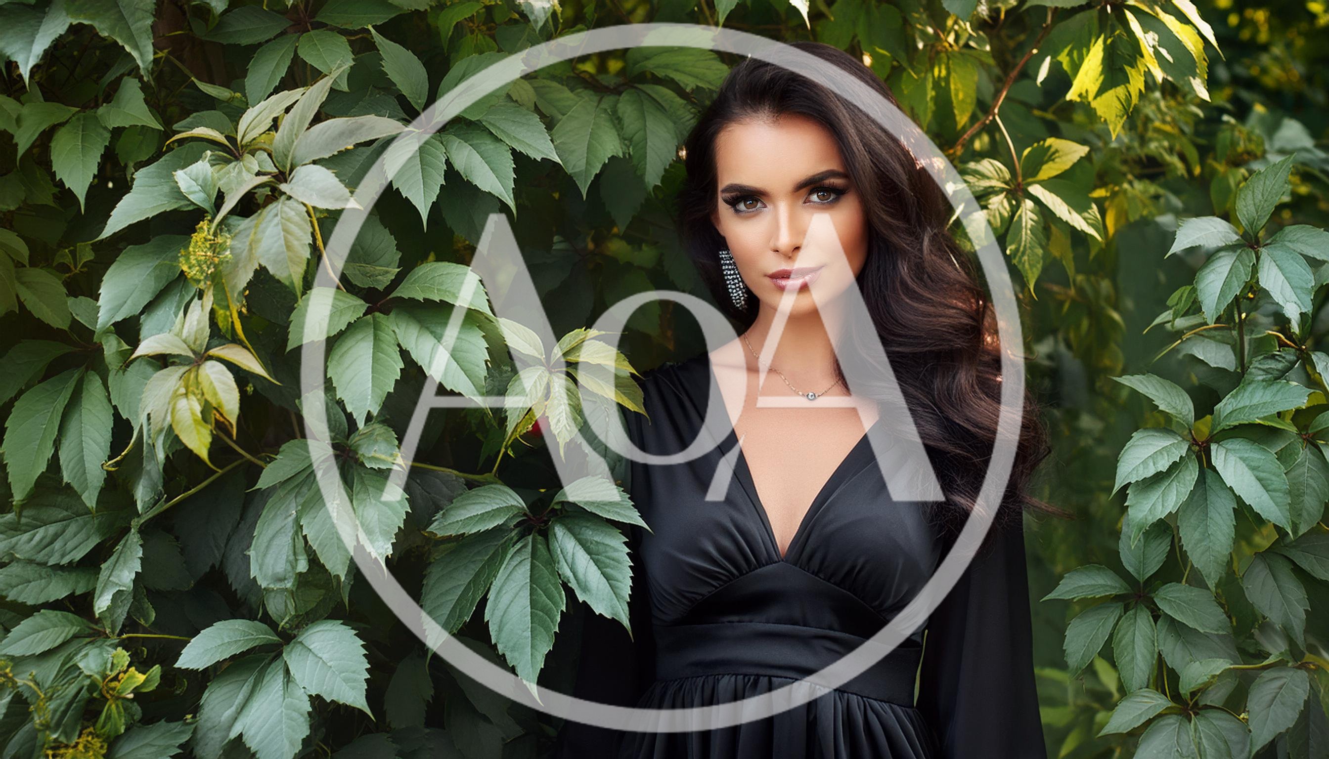 Elegant Woman In Black Dress Standing Before Green Foliage