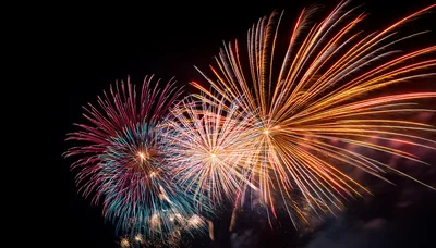 Vibrant Multi-Colored Fireworks Display Against Dark Night Sky