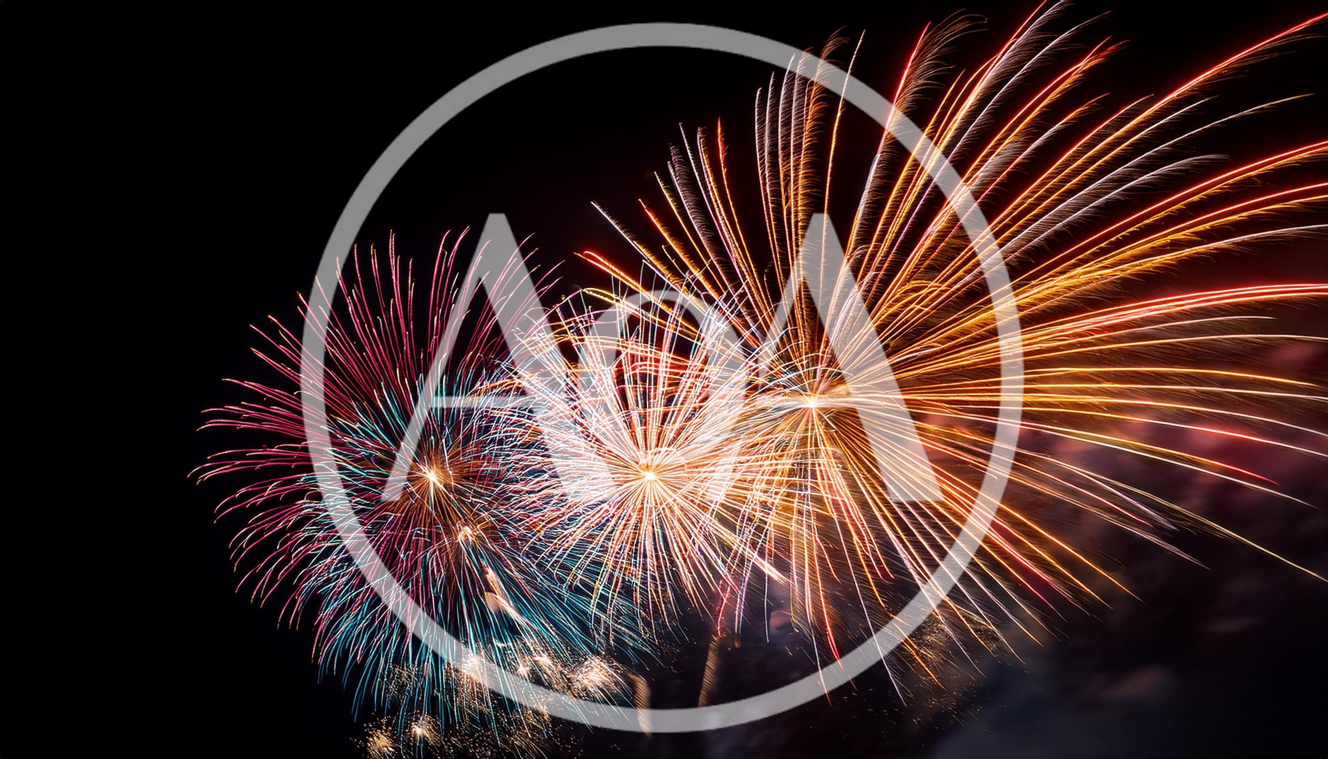 Vibrant Multi-Colored Fireworks Display Against Dark Night Sky
