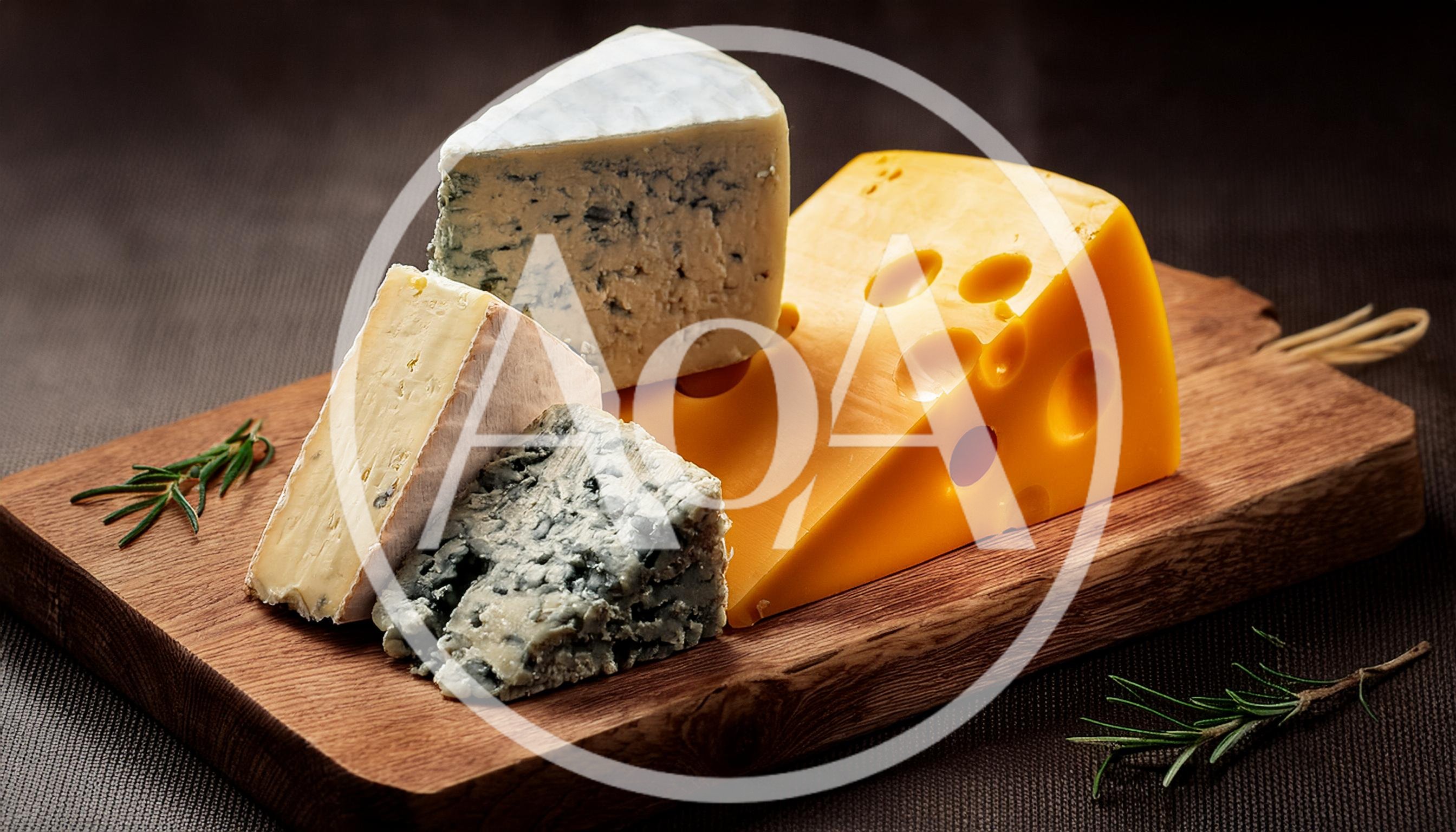 Assorted Cheese Varieties on a Wooden Serving Board