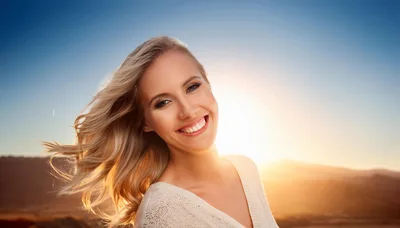 Smiling Blonde Woman With Windblown Hair At Sunset