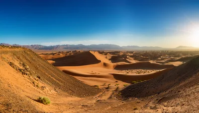 Panoramic View Of Vast Desert Sand Dunes At Sunset