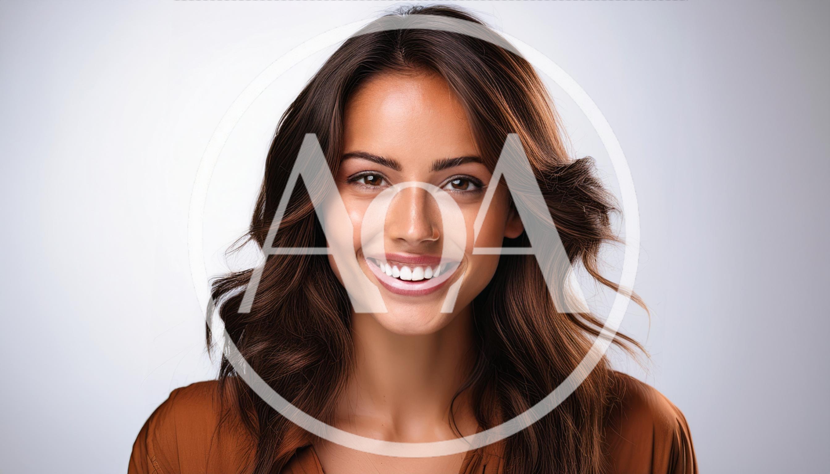 Portrait Of A Smiling Woman With Wavy Brown Hair