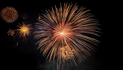 Golden Fireworks Bursting Against Dark Night Sky