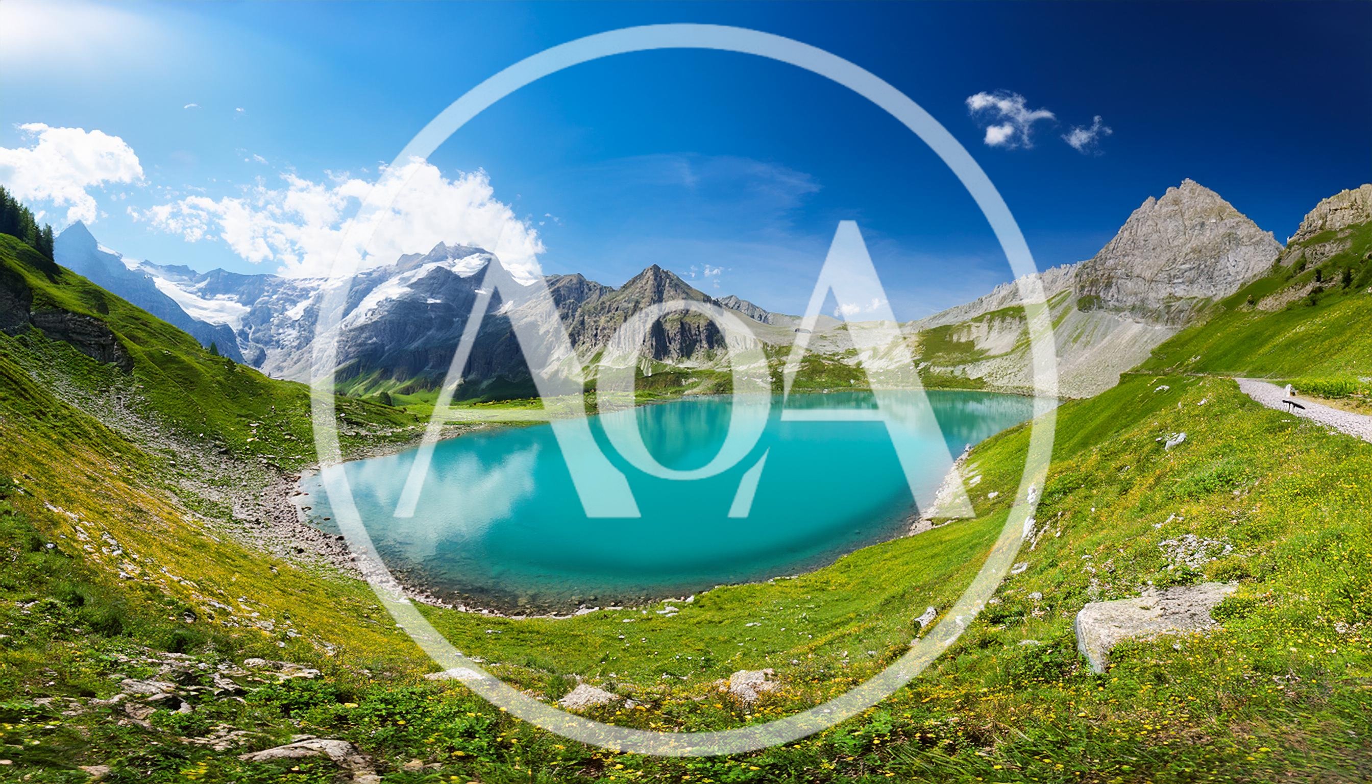 Turquoise Alpine Lake Surrounded By Lush Green Mountains