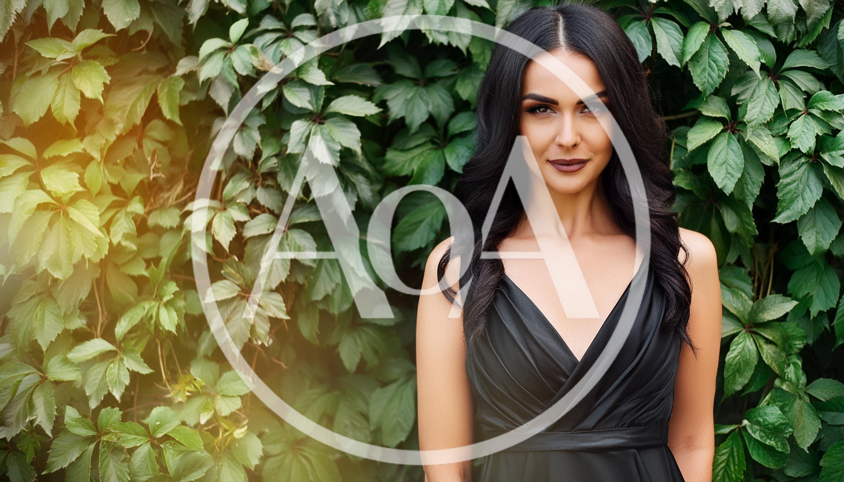 Elegant Woman With Dark Hair Posing Against Ivy Wall