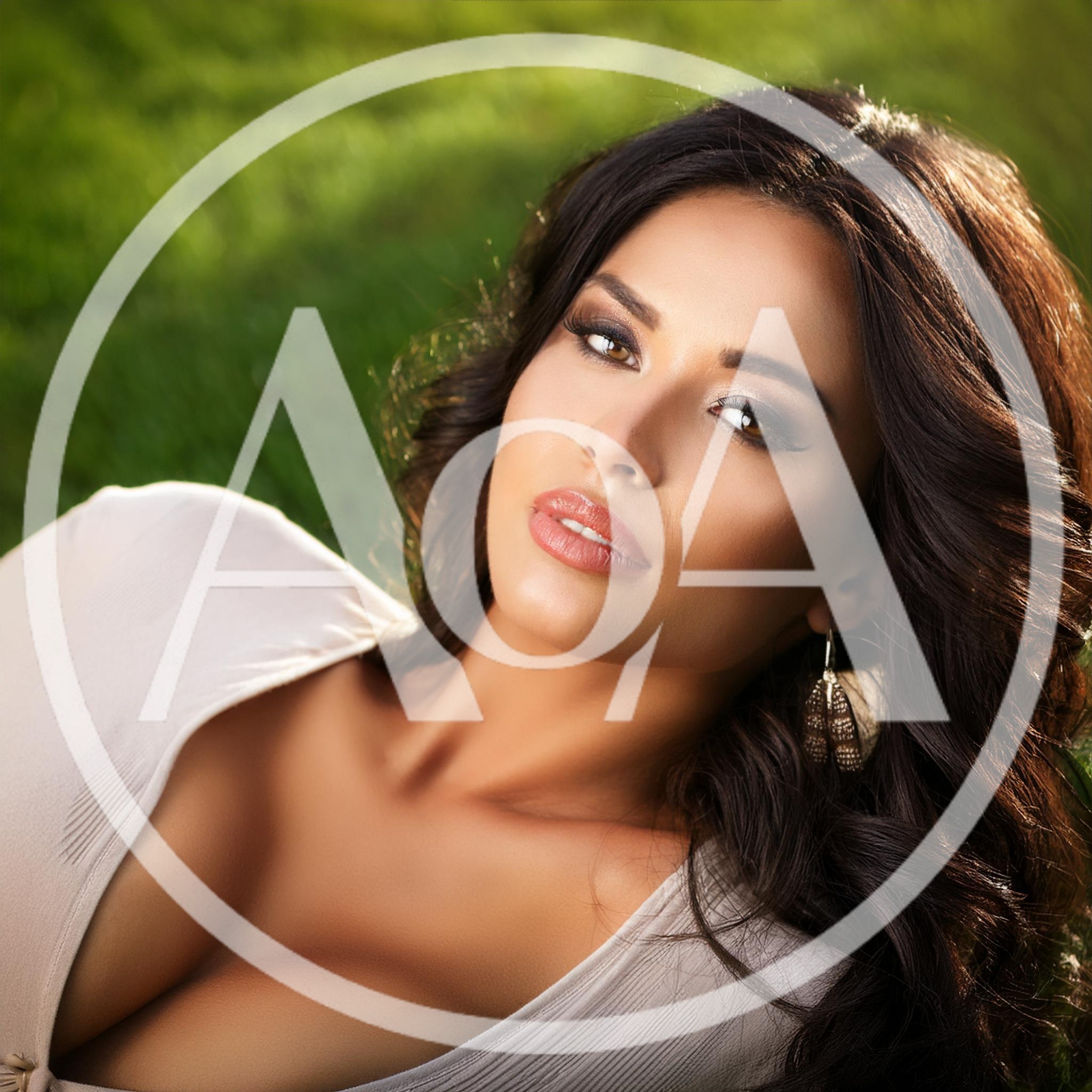 Beautiful Woman With Long Dark Hair Lying On Grass