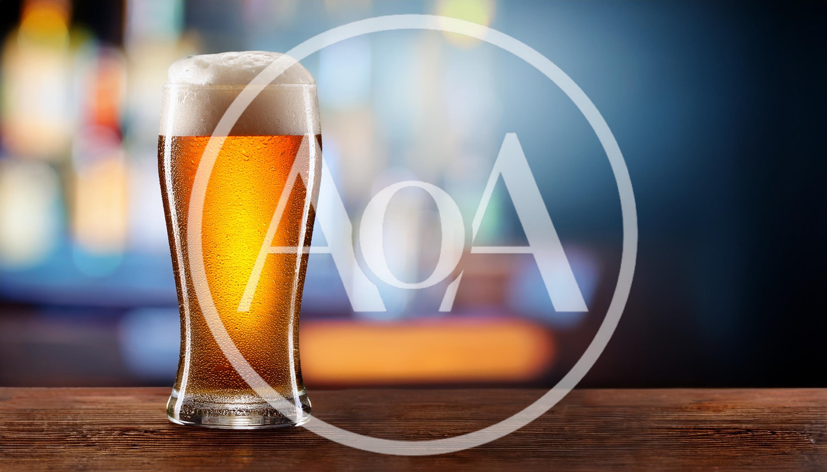 Cold Glass Of Beer On A Wooden Bar Counter