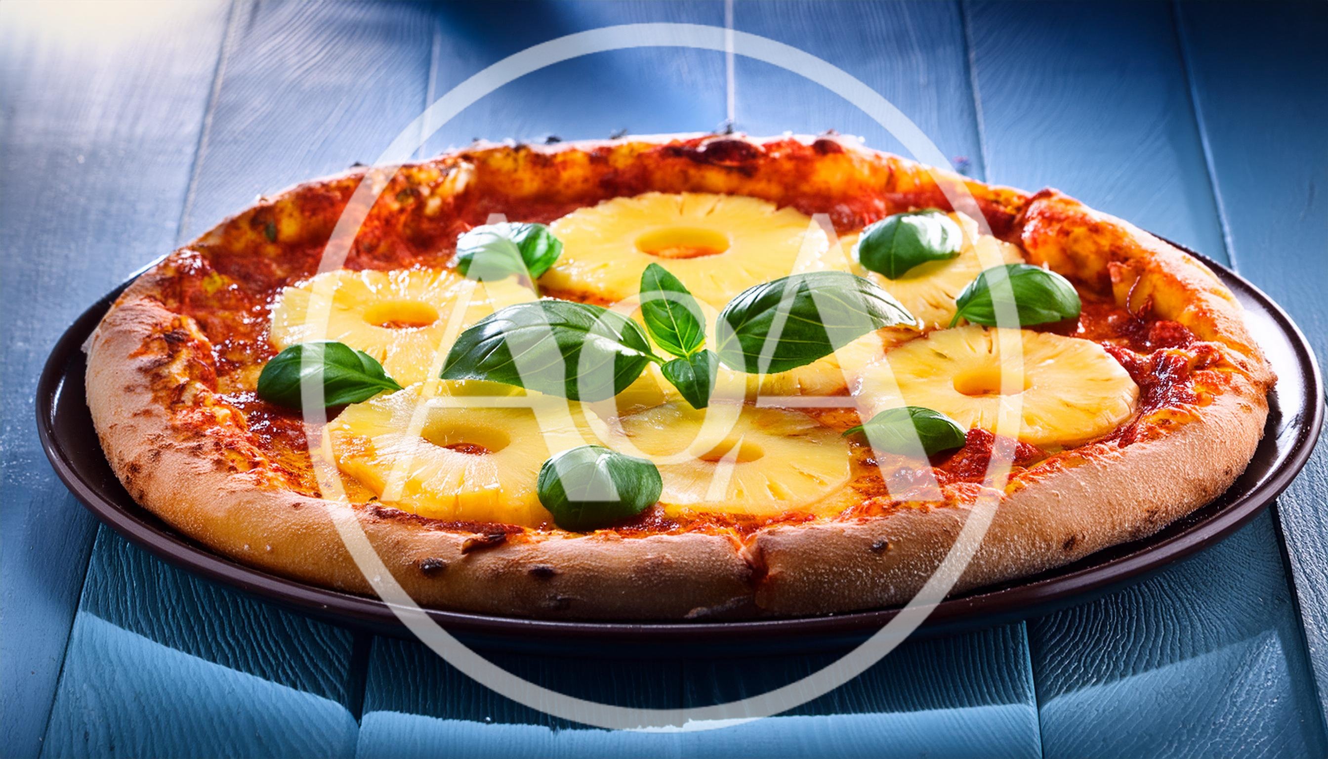 Fresh Pineapple Pizza With Basil Leaves On Blue Wood