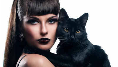 Fashion Portrait Of A Woman Holding A Black Cat