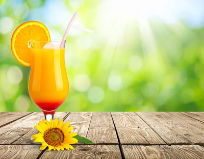 Refreshing Tequila Sunrise Cocktail With Sunflower On Wooden Table