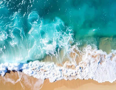 Aerial View Of Turquoise Ocean Waves Crashing On Beach