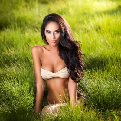 Beautiful Woman Posing In Lush Green Grass
