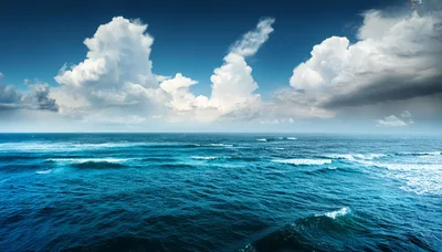 Vast Blue Ocean Waves Under Dramatic Cloudy Sky