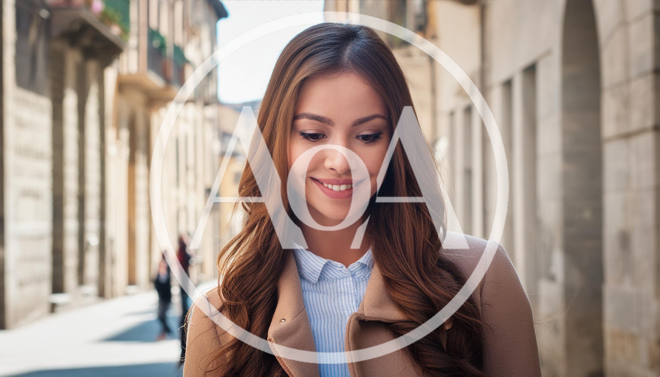 Young Woman Smiling While Walking Down A City Street