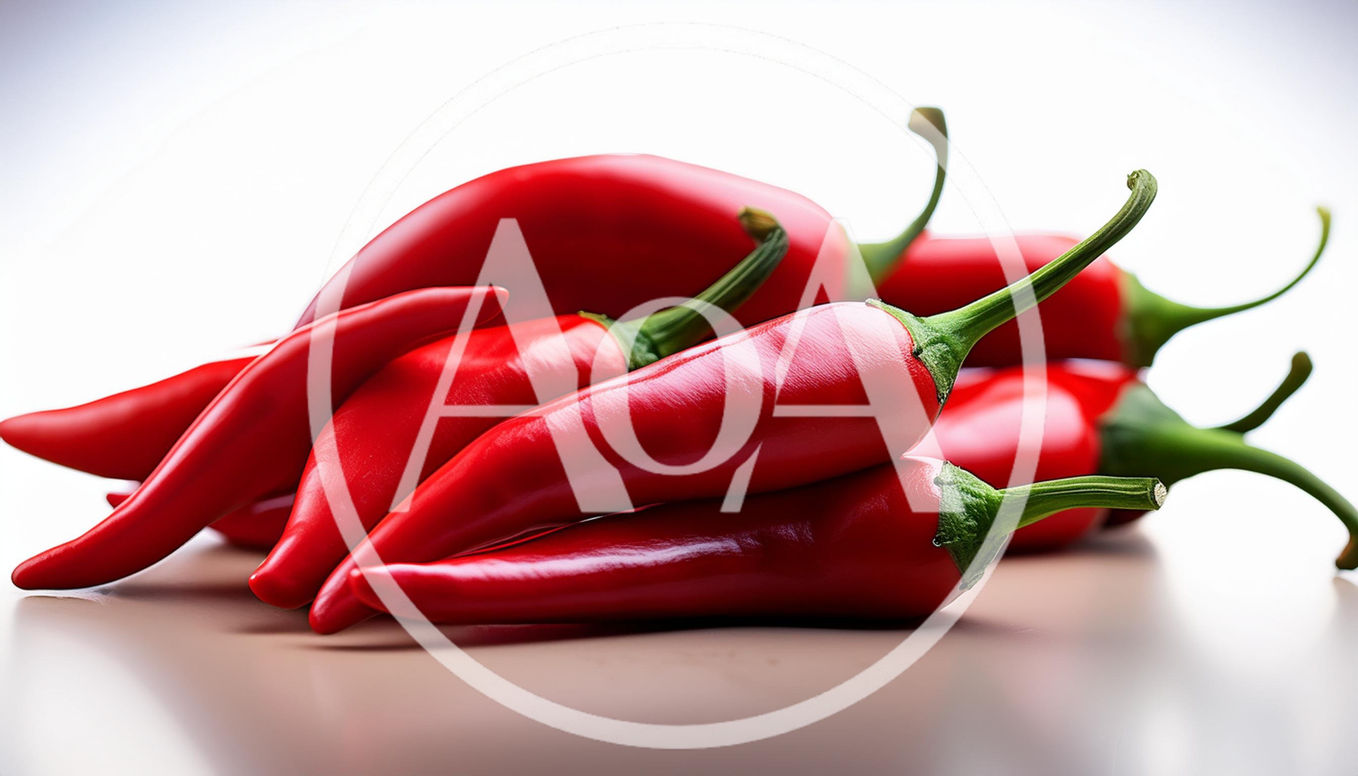 Fresh Red Chili Peppers On A White Surface