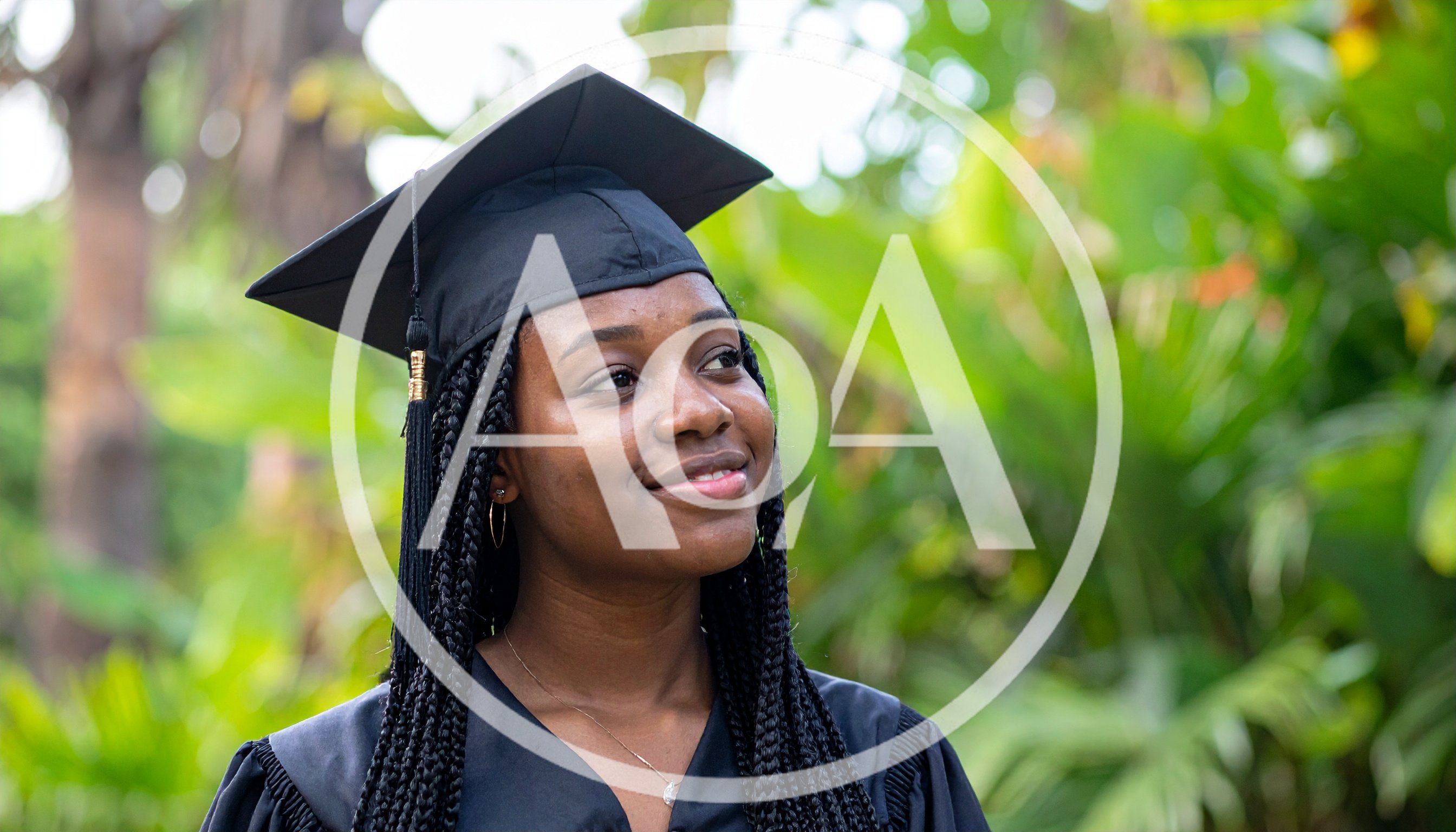 Young Black Woman Wearing Graduation Cap And Gown