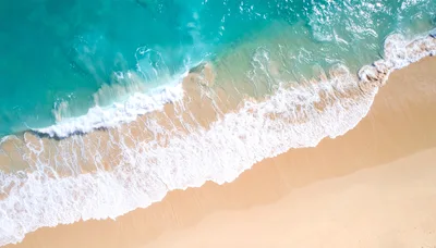 Aerial View Of Turquoise Ocean Waves Crashing On Beach