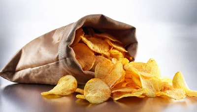 Potato Chips Spilling From A Brown Fabric Sack