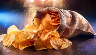 Potato Chips Spilling From A Burlap Sack