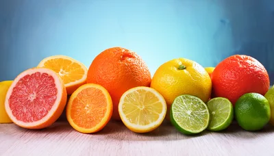 Assorted Fresh Citrus Fruits on Wooden Surface