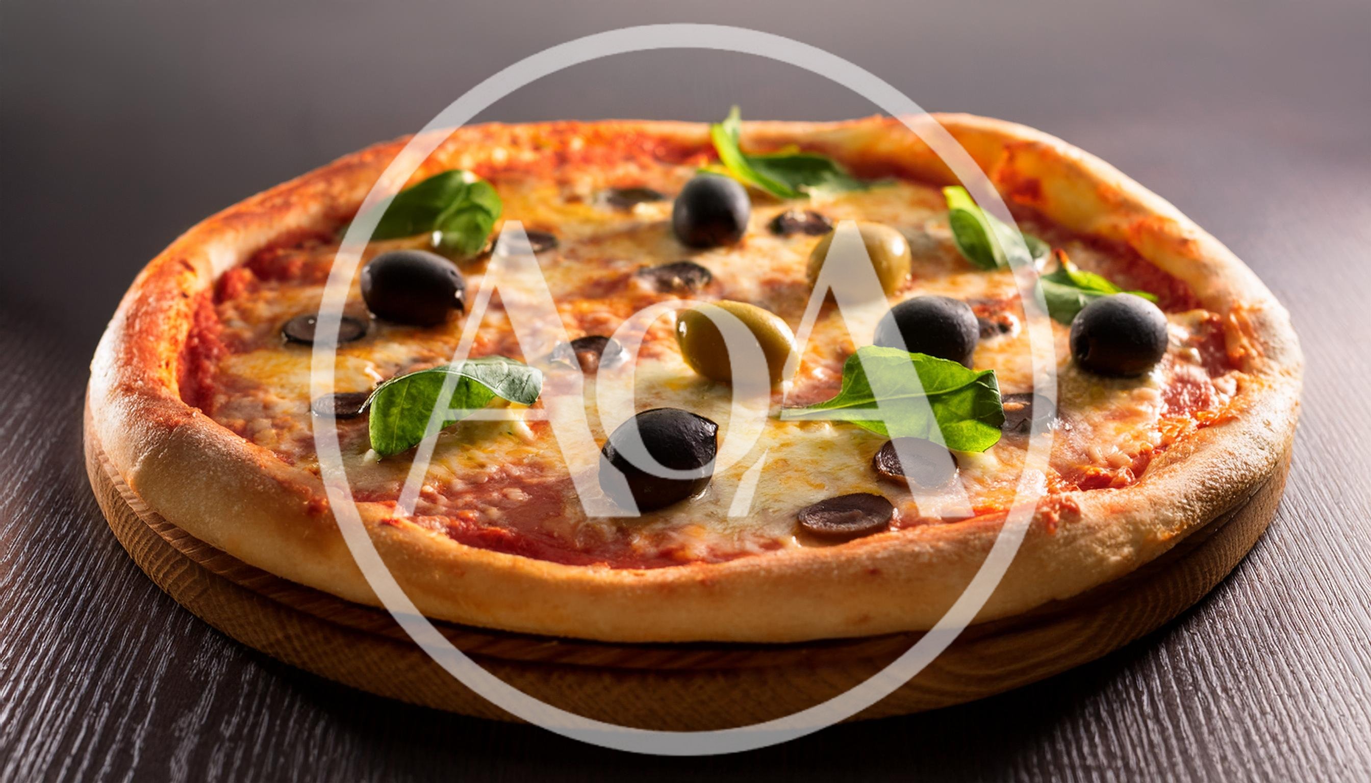 Freshly Baked Pizza With Olives And Basil Leaves