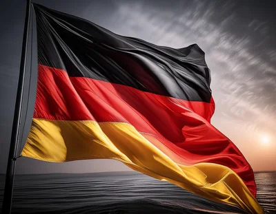German Flag Waving Against A Dramatic Sunset Sky