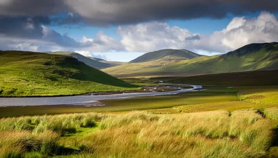 Winding River Through Lush Green Scottish Highlands Valley