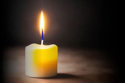 Single Lit Candle With Glowing Flame