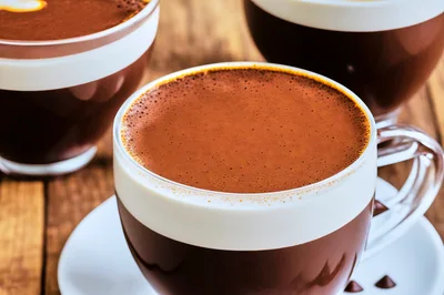 Three Cups Of Hot Chocolate On Wooden Table
