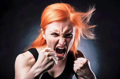Angry Woman With Red Hair Screaming And Clenching Fists