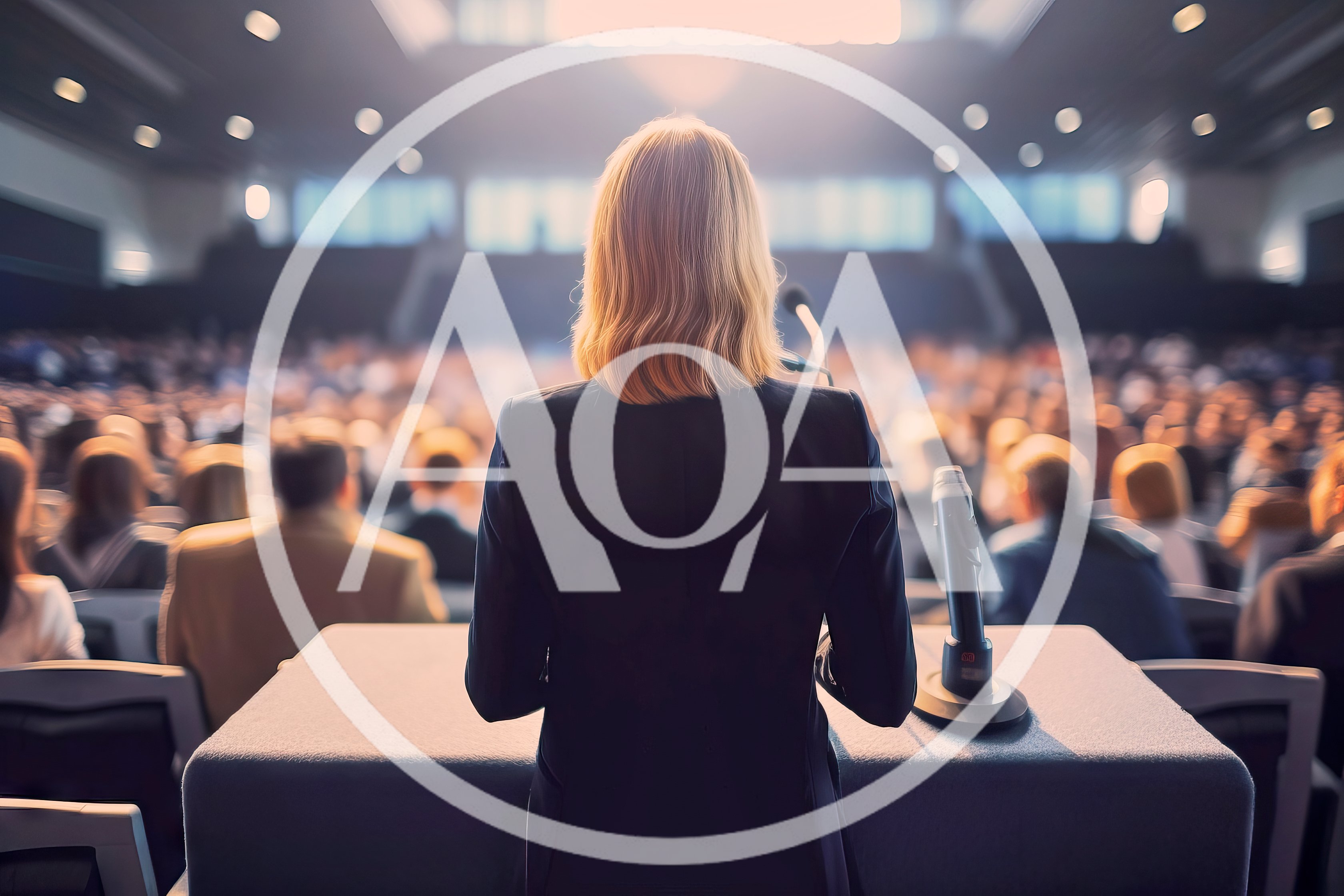 Businesswoman Giving A Presentation To A Large Audience