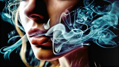 Close Up Of A Woman Exhaling Smoke