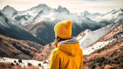 Woman Wearing Yellow Jacket Looking At Snowy Mountains