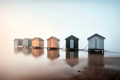 Row Of Colorful Bathing Boxes On Brighton Beach