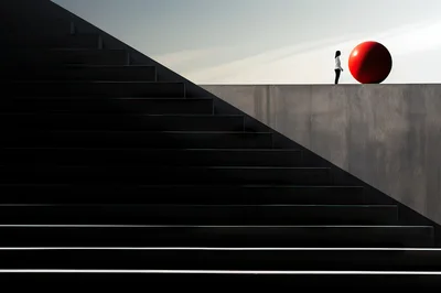 Minimalist Composition With Person And Red Sphere